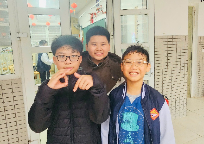 A group of boys standing in front of a door

Description automatically generated